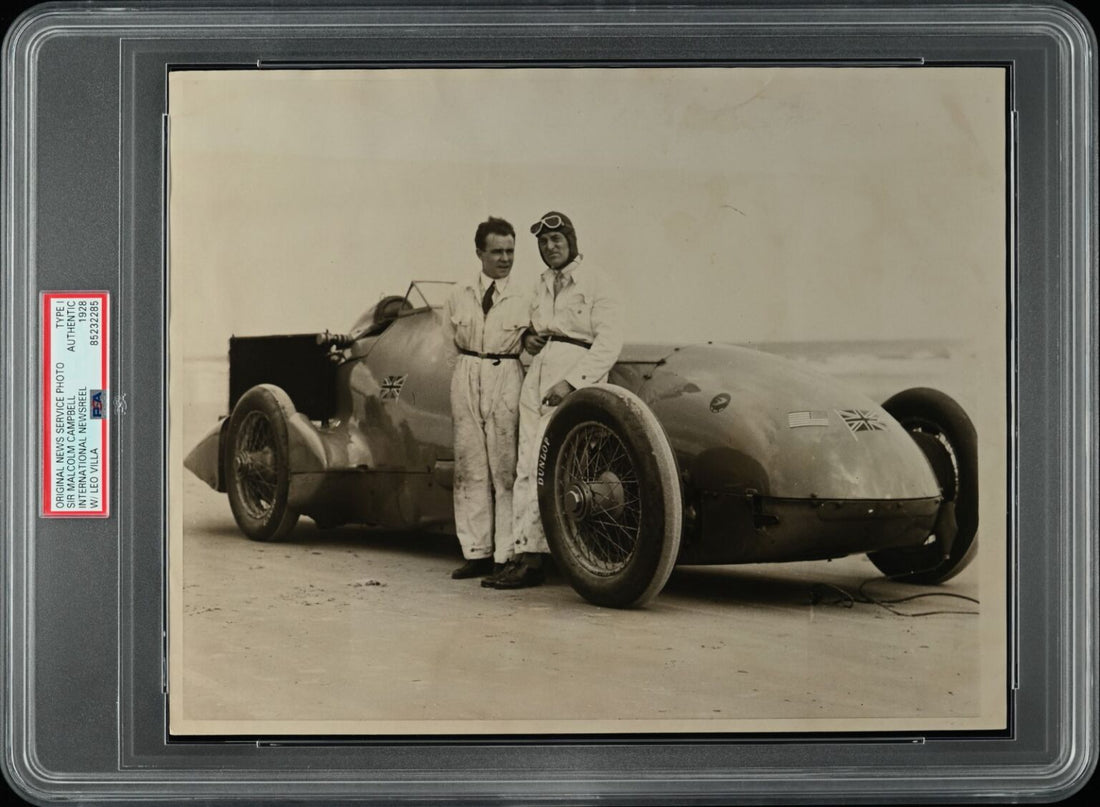 PSA encapsulated International Newsreel photograph of Sir Malcolm Campbell and Leo Villa at Daytona Beach, 1928, following the Napier Blue Bird world land speed record.