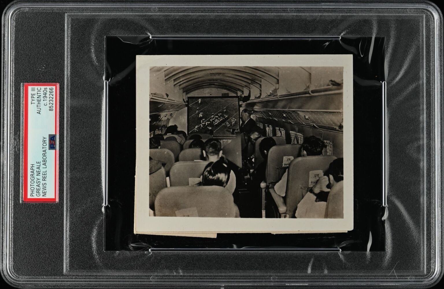 PSA/DNA encapsulated Newsreel Laboratory photograph of Greasy Neale coaching players aboard an aircraft during team travel, circa 1939.